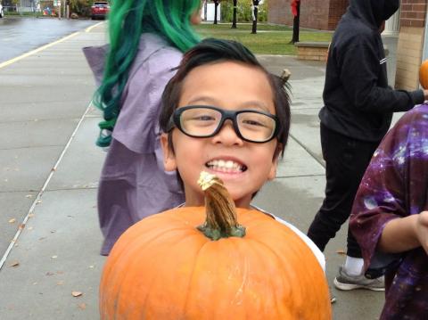 student with their pumpkin