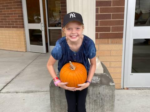 Student with a pumpkin