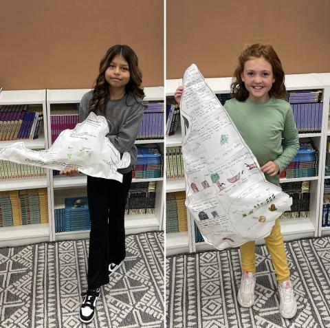 Students showing their 12 colony balloon