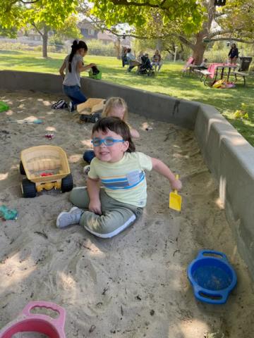 student playing in the sand