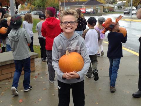 Student excited to receive their pumpkin