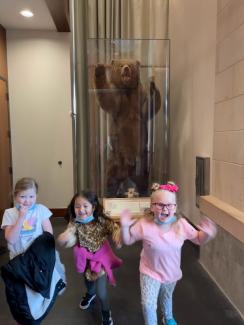 students with a bear at the bean museum
